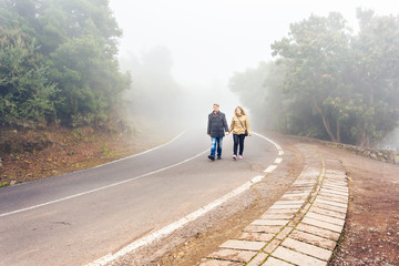 romantic  scene of couples foggy day on the road
