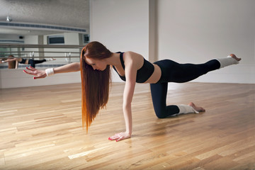 young woman doing stretching or ballet exercises