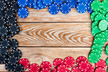 Poker chips over wooden background