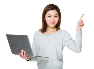 Asian Woman hold with laptop computer and finger point up