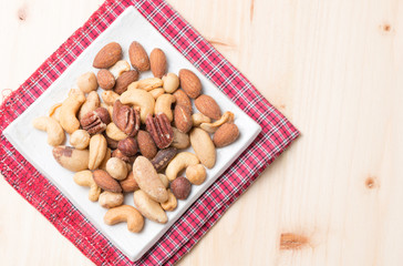 mix of various nuts on wood background