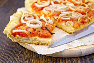 Pie with onions and tomatoes on parchment