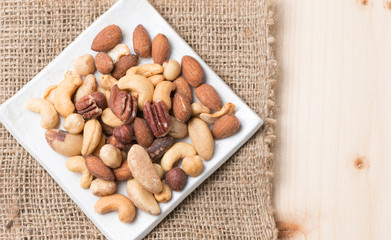 mix of various nuts on wood background