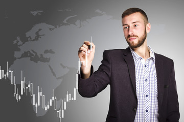 Businessman drawing a financial graph