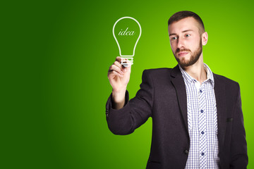 Businessman drawing light bulb