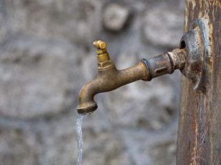 Broken old tap, dripping, outdoors. Maybe metaphor. - obrazy, fototapety, plakaty