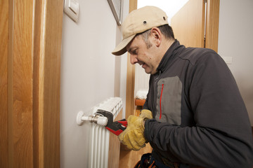 Plumber fixing a radiator