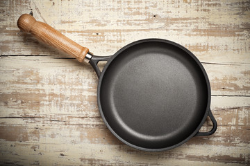 frying pan on aged wood