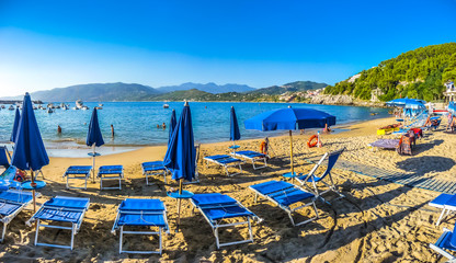 Vacation beach scenery with beachchairs and sunshades on a sunny day