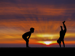 silhouette of two little boys playing sunset sky