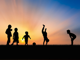 Fototapeta na wymiar silhouette of five little boys playing in sunset sky