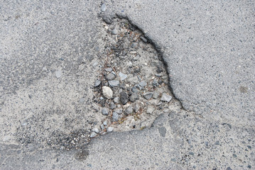 close up road with potholes