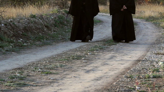 Christian monks walking on a country road