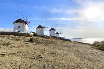 Five windmills in Chora,Mykonos,Greece.Traditional greek whitewashed architecture,a popular landmark,tourist destination on the island of winds,deep blue sky,Aegean sea. Wind mills are now decorative.