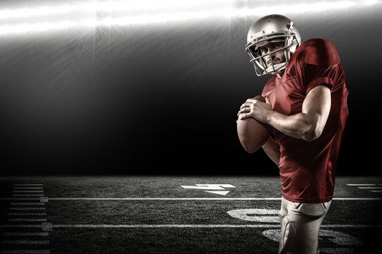 Composite image of serious american football player in red