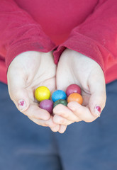 Child hands holding toy marbles