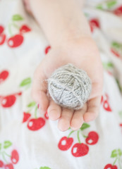 Ball of yarn in hand of child