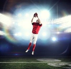 Fototapeta na wymiar Composite image of american football player catching football