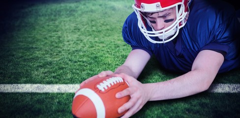 Composite image of american football player scoring a touchdown