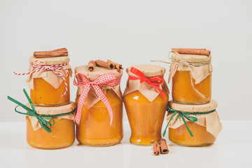 Different sort of pumpkin and orange jam, isolated on white background