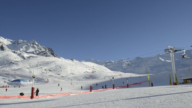 People skiing on a ski piste in the town of Val Thorens, France. 