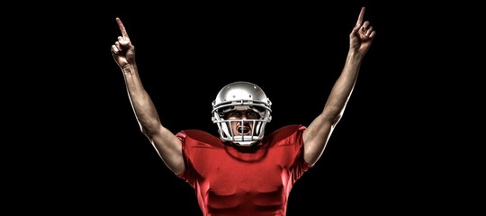 American football player with arms raised cheering