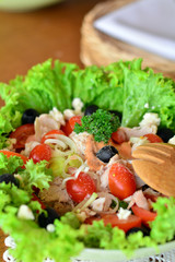 Mixed vegetable salad with chicken in the white bowl