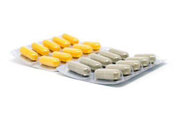Herb powder capsule in blister pack on white background