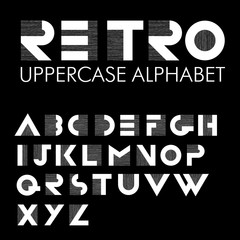 Wide decorative retro alphabet. White letters on black backgroun