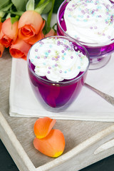 Colorful jelly with whipped cream and candy topping