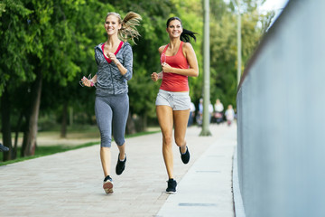 Fit women jogging outdoors