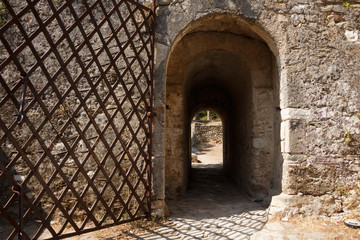 Fototapeta premium Ancient stone gate with metal door