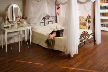 Lifeless woman lying on a bed