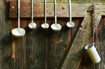 Ladle different sizes Hanging on an old wooden door