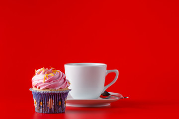 Colored cupcake on brigth red background