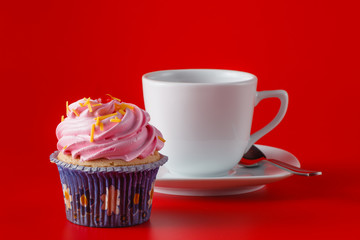 Colored cupcake on brigth red background