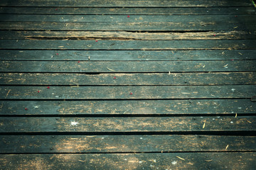 old wooden walkway with falling leaves in the morning of autumn