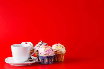 Colored cupcake on brigth red background