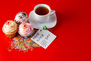 Fun children breakfast. Cupcake on brigth red background