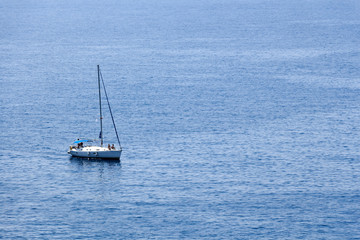 Deep blue sea seascape background with sailing boat.