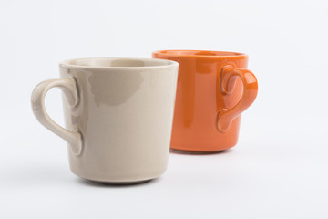 Orange offee cup and brown offee cup on white background