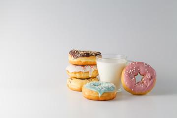 Colored donuts on white plain background