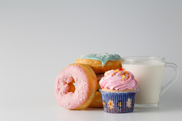 Colored donuts on white plain background