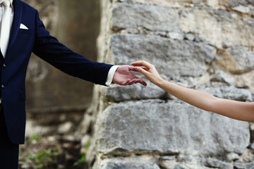 the hands of a bride and husband