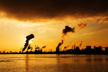 Fototapeta na wymiar Sunset view of the heavy industry with smoking chimneys in IJmuiden, the Netherlands