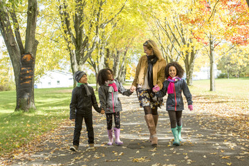 Obraz premium Happy family having fun on beautiful autumn day