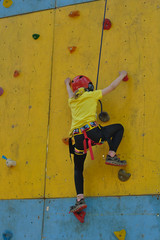 Child climbing on a climbing wall