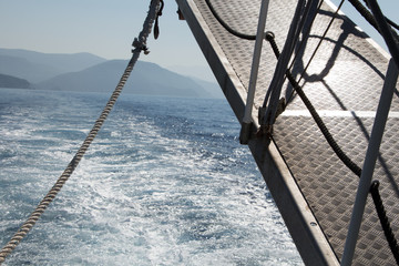 Bridge of a boat closeup with sea and mountains view behind it