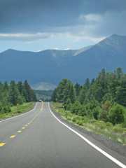 Road through landscape in Arizona, United States on a sunny and cloudy day in July.