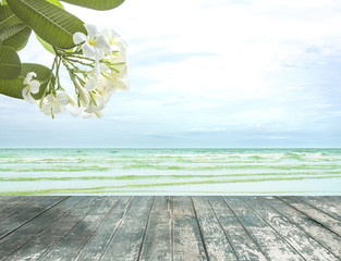 Plakat Plumeria flowers on sea view with old wooden floor